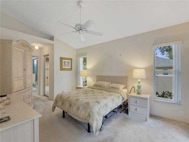 bedroom with ceiling fan, light colored carpet, and vaulted ceiling