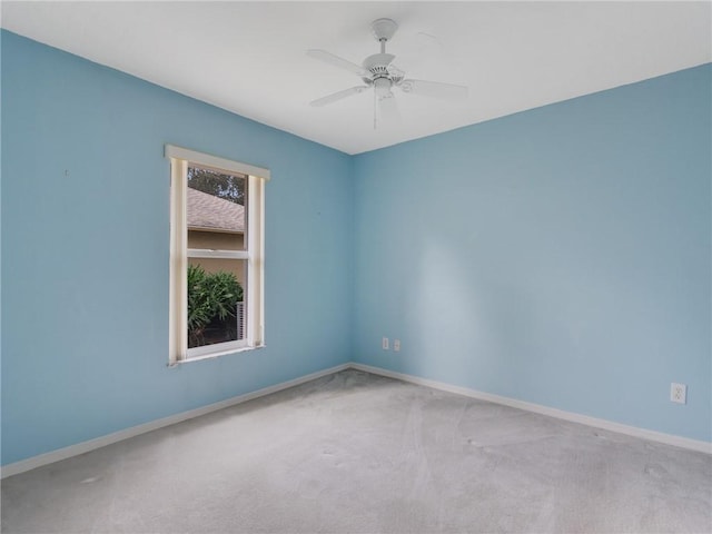 carpeted empty room featuring ceiling fan