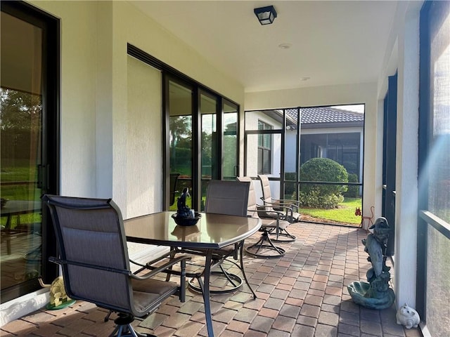 sunroom / solarium with brick floor