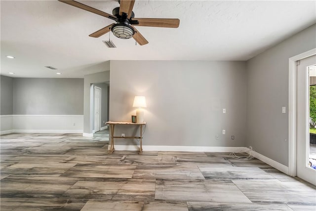 empty room featuring ceiling fan and a healthy amount of sunlight