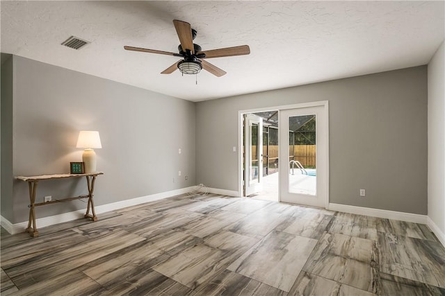 unfurnished room featuring a textured ceiling and ceiling fan