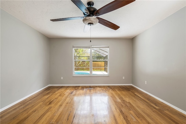 spare room with light hardwood / wood-style floors and ceiling fan