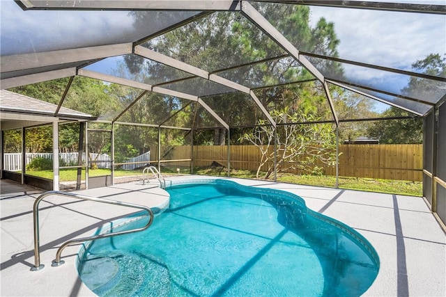 view of pool featuring a patio and glass enclosure