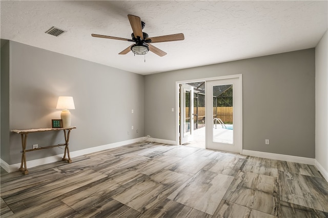 spare room featuring a textured ceiling and ceiling fan