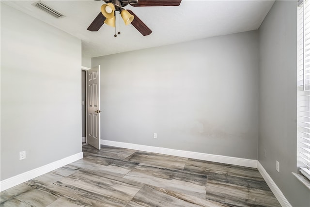 empty room with a healthy amount of sunlight and ceiling fan