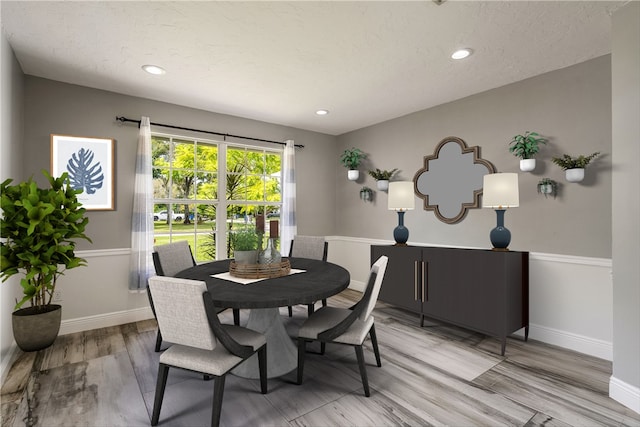 dining area with light wood finished floors, baseboards, and recessed lighting