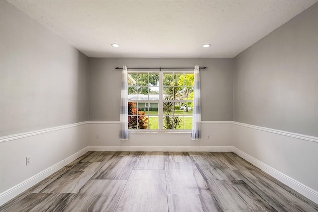 unfurnished room featuring hardwood / wood-style floors