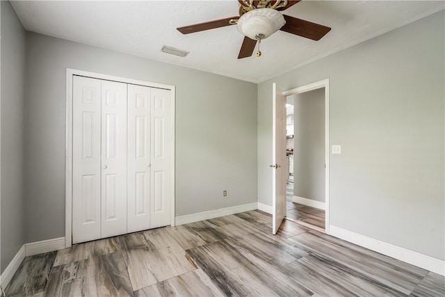 unfurnished bedroom featuring a closet, ceiling fan, and light wood-type flooring