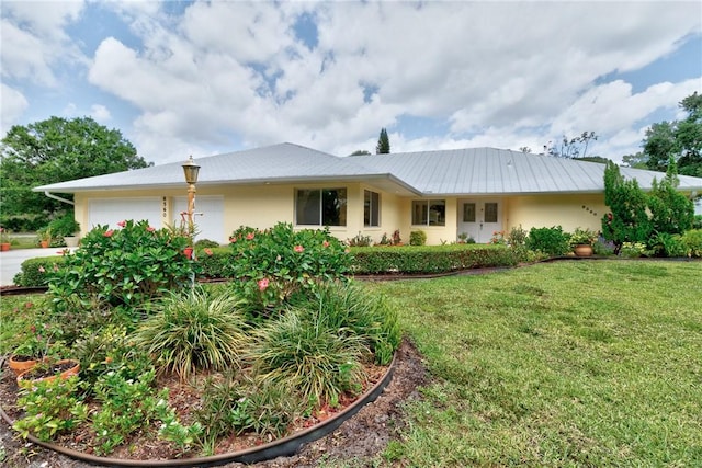 8560 De Haviland Ct, Vero Beach, FL 32968 - single story home featuring an attached garage, a front lawn, and stucco siding