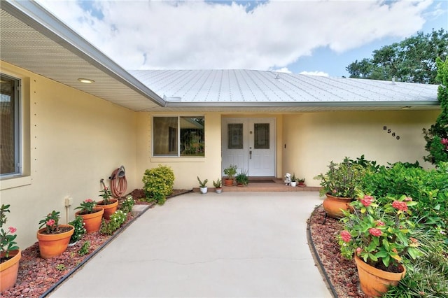 8560 De Haviland Ct, Vero Beach, FL 32968 - entrance to property featuring metal roof and stucco siding
