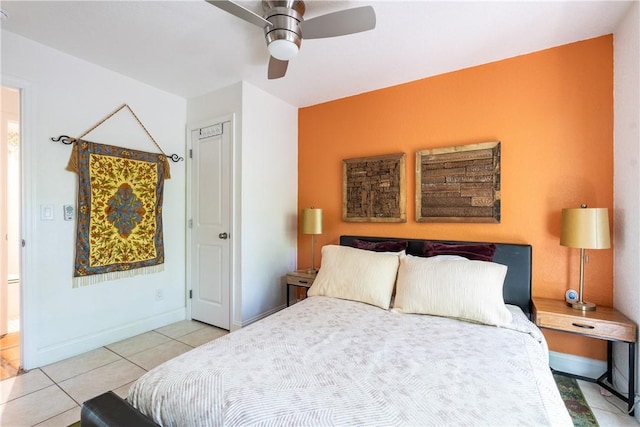 bedroom with ceiling fan and light tile patterned floors