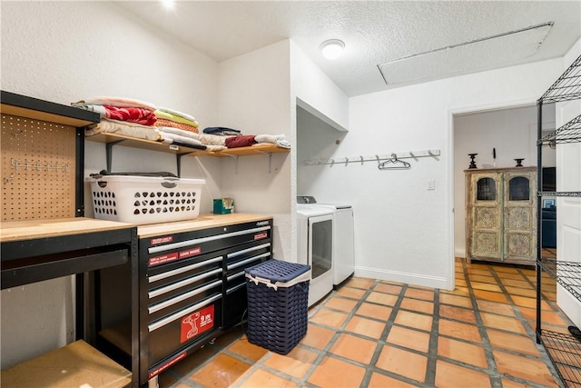 clothes washing area featuring washer and dryer, a textured ceiling, and tile patterned floors