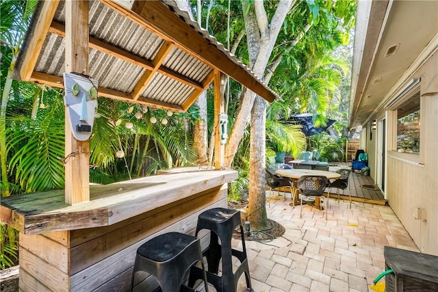 view of patio / terrace with an outdoor bar and a deck