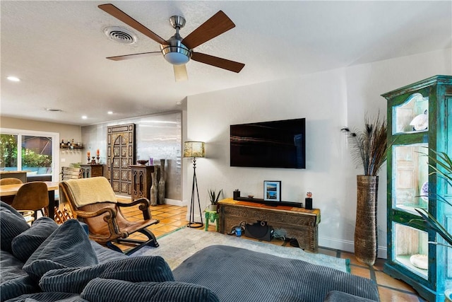 tiled living room with ceiling fan