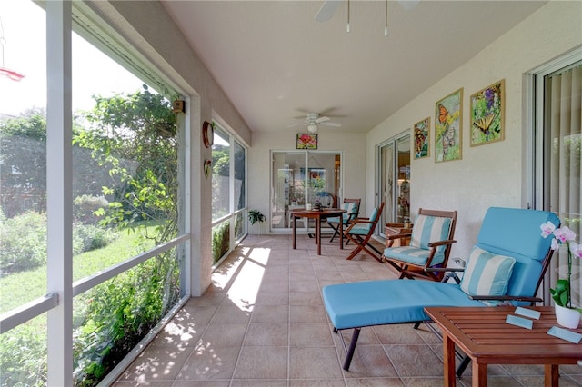 sunroom featuring ceiling fan