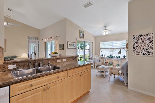 kitchen featuring lofted ceiling, sink, light tile patterned floors, ceiling fan, and light brown cabinetry