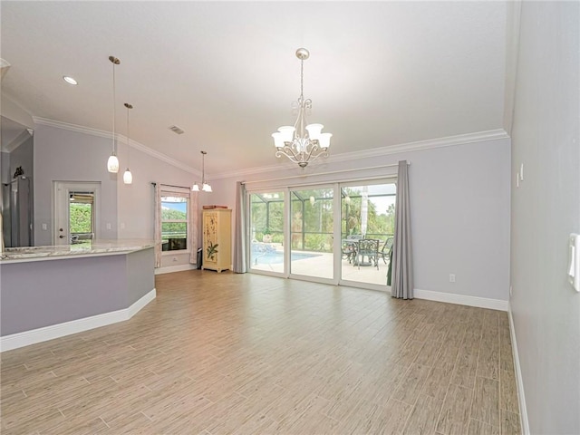 unfurnished living room with light hardwood / wood-style flooring, an inviting chandelier, crown molding, and vaulted ceiling