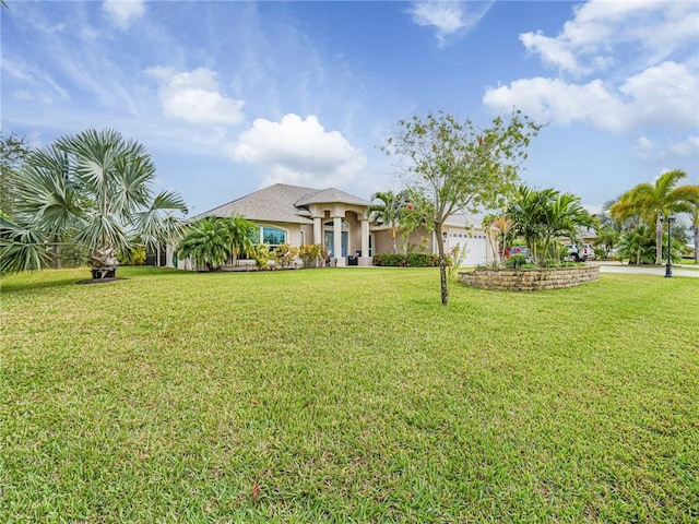 view of front facade featuring a front yard and a garage