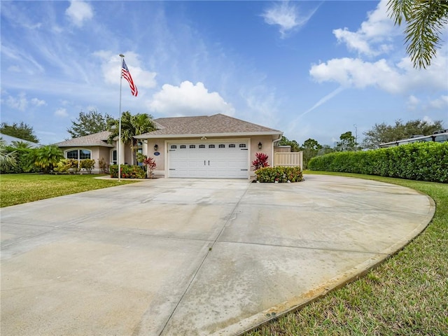 view of front of property with a front yard and a garage