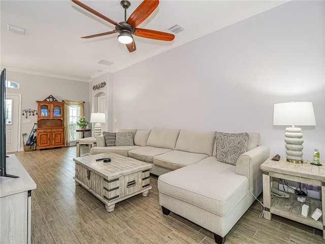 living room with ceiling fan and ornamental molding