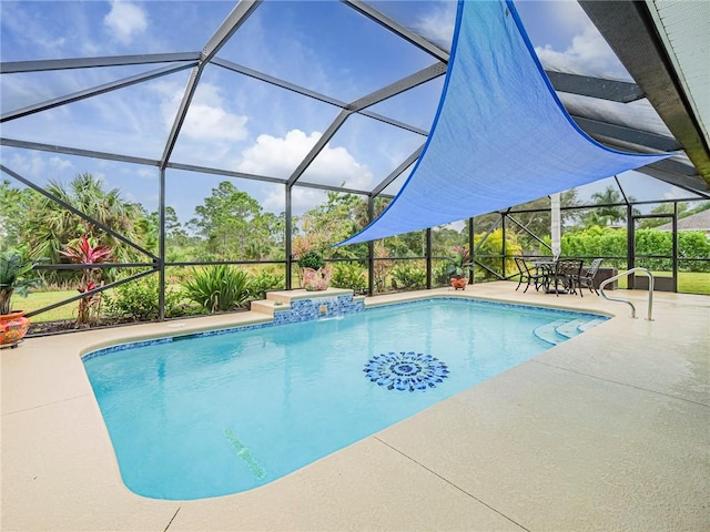 view of swimming pool featuring glass enclosure and a patio area