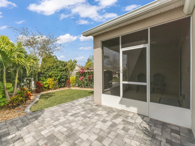 view of patio / terrace featuring a sunroom