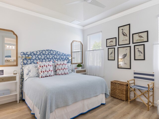 bedroom featuring light hardwood / wood-style floors, ceiling fan, and ornamental molding