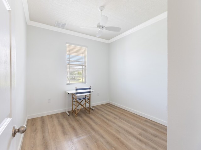 empty room featuring ornamental molding, a textured ceiling, ceiling fan, and light hardwood / wood-style flooring