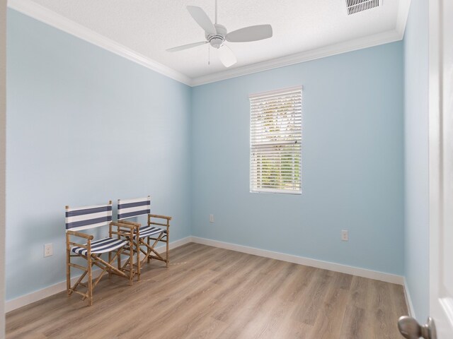 spare room featuring ceiling fan, a textured ceiling, crown molding, and light hardwood / wood-style flooring