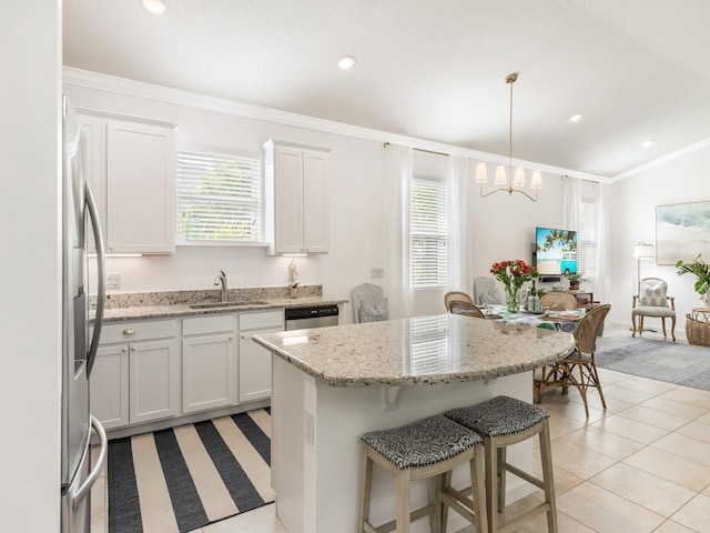 kitchen with white cabinets, plenty of natural light, sink, and decorative light fixtures