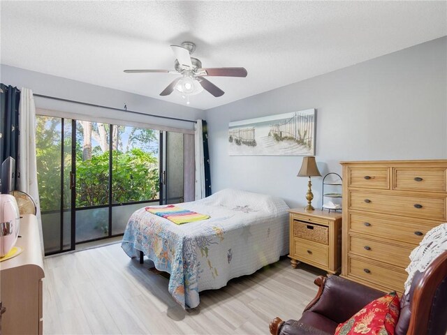 bedroom featuring access to exterior, ceiling fan, and light hardwood / wood-style floors