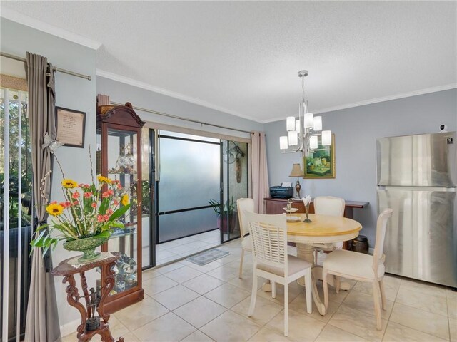 tiled dining space featuring a notable chandelier and crown molding