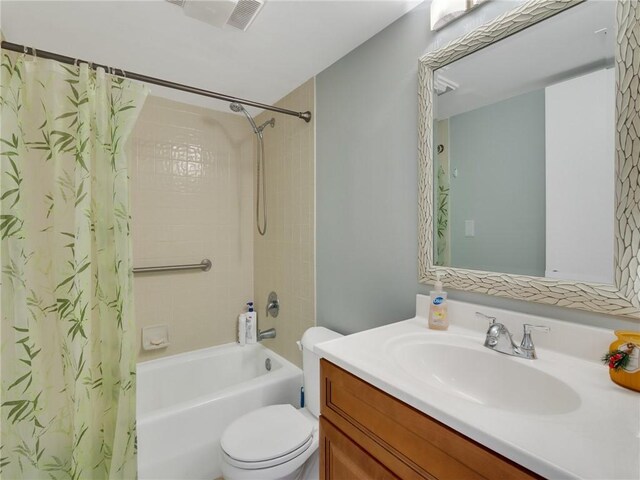 full bathroom with vanity, shower / tub combo, and toilet