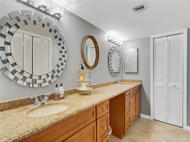 bathroom with tile patterned flooring and vanity