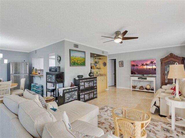 living room with ceiling fan, light tile patterned floors, and crown molding