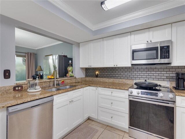 kitchen featuring ornamental molding, stainless steel appliances, sink, white cabinetry, and light tile patterned flooring