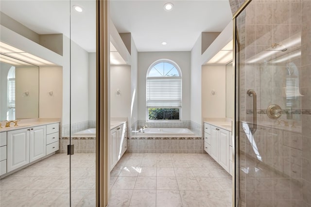 full bath featuring tile patterned floors, a garden tub, two vanities, recessed lighting, and a shower stall