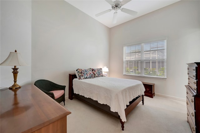 bedroom with ceiling fan, baseboards, and light carpet