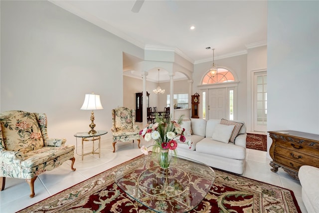 tiled living area featuring arched walkways, crown molding, and decorative columns