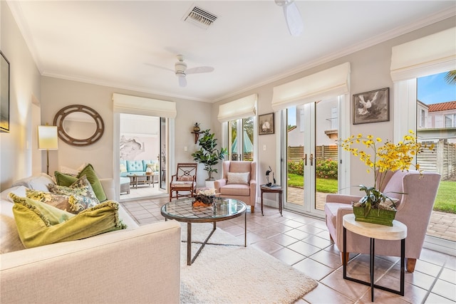 tiled living room with ceiling fan and crown molding