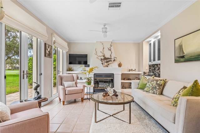 tiled living room featuring ornamental molding and ceiling fan