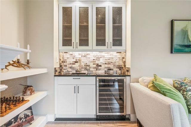 bar featuring white cabinets, light tile patterned floors, tasteful backsplash, and wine cooler