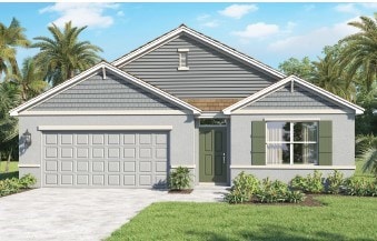 view of front of house with a front lawn, driveway, and an attached garage