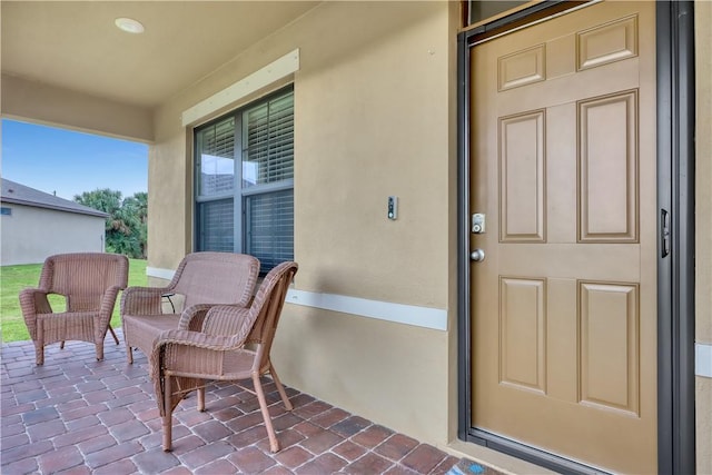 view of exterior entry with covered porch