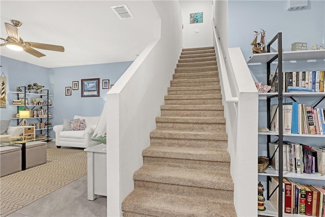 stairs with ceiling fan