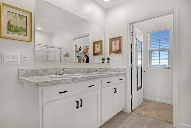 bathroom featuring a shower with shower door, tile patterned floors, and vanity