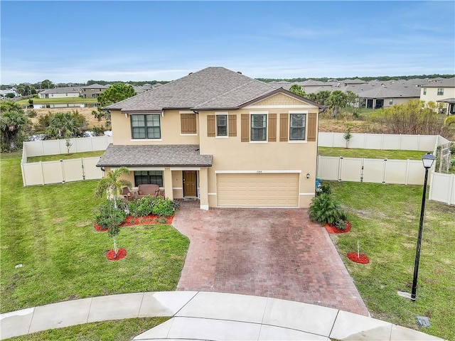 view of front of property with a garage and a front lawn