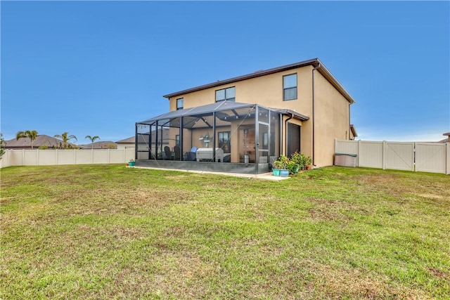 back of house with a lanai, a yard, and a patio