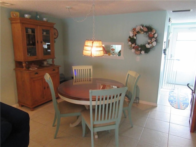 dining area with light tile patterned floors