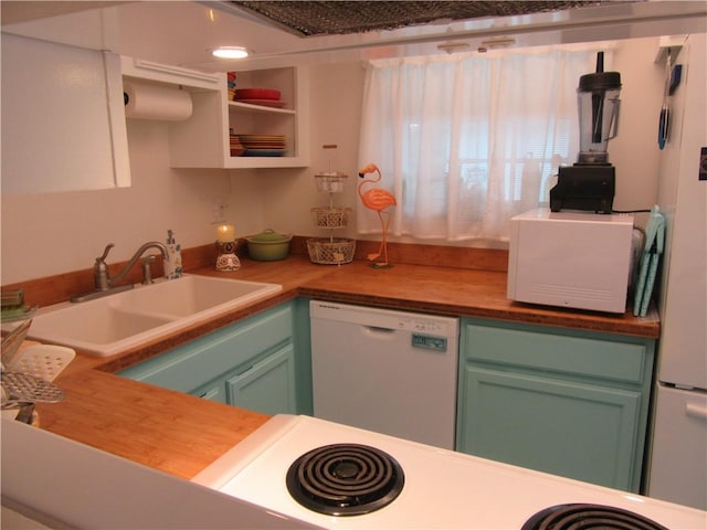 kitchen featuring white appliances, white cabinets, sink, butcher block countertops, and green cabinets